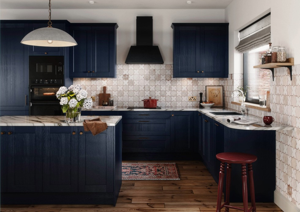 Dark blue shaker kitchen with island, marble worktop and matt grey extractor
