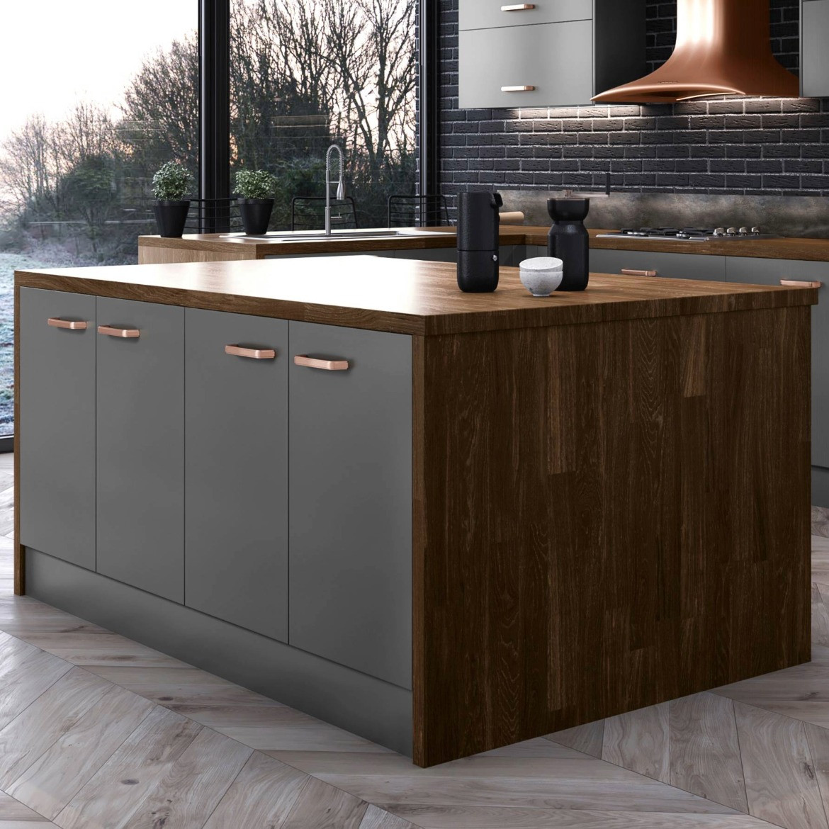 Close up of a kitchen island in the Modica Dust Grey with a waterfall effect worktop. The countertop is plank nogal.