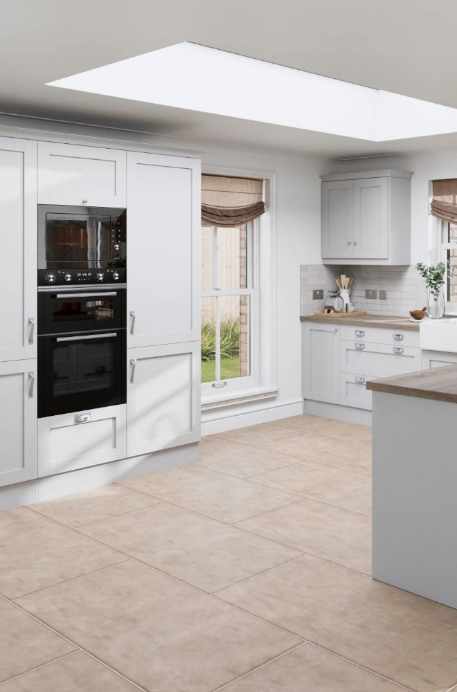 Shaker Light Grey kitchen including tall units with double ovens and a peninsula with oak worktop