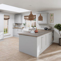 Shaker Light Grey kitchen, including a peninsula with oak worktop and a downdraft extractor hob